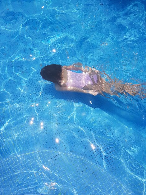 High angle view of woman swimming in pool