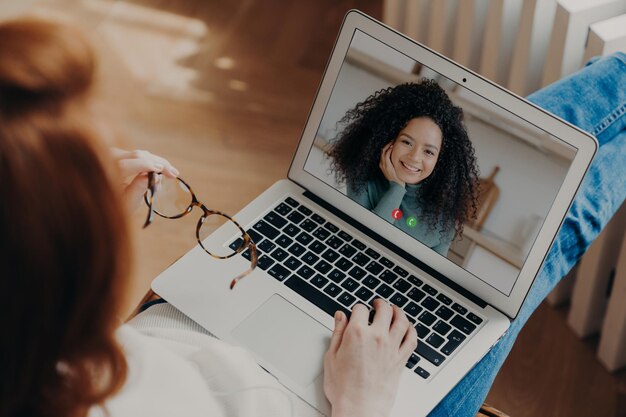 High angle view of woman using laptop at home