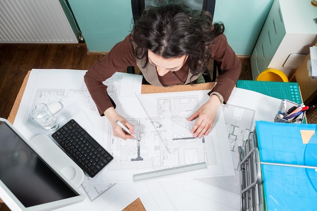 High angle view of woman using laptop at office