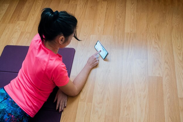 High angle view of woman using mobile phone at home