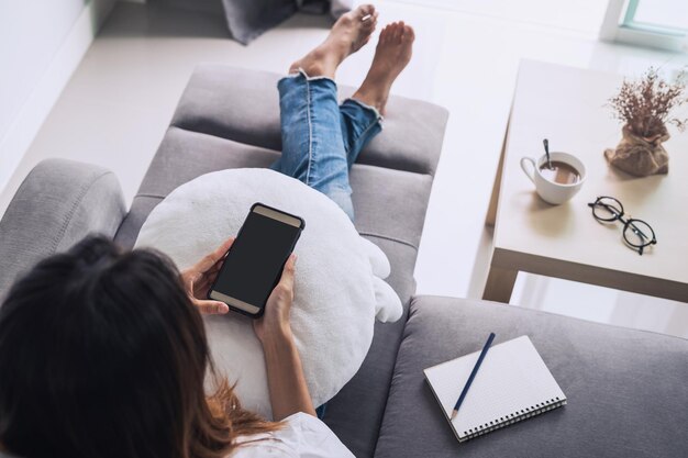 High angle view of woman using mobile phone at home