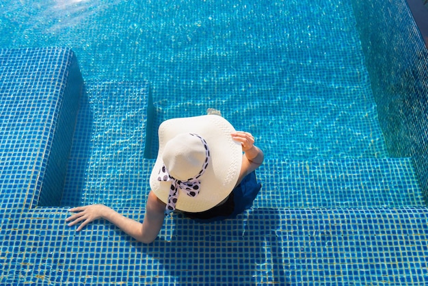 High angle view of woman wearing hat in swimming pool