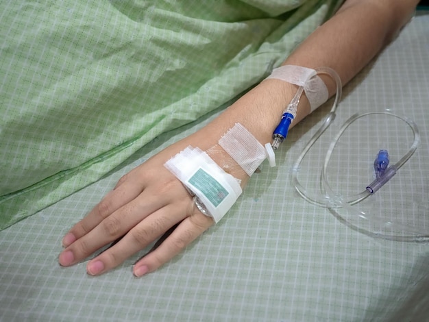 High angle view of woman with medical equipment on bed in hospital