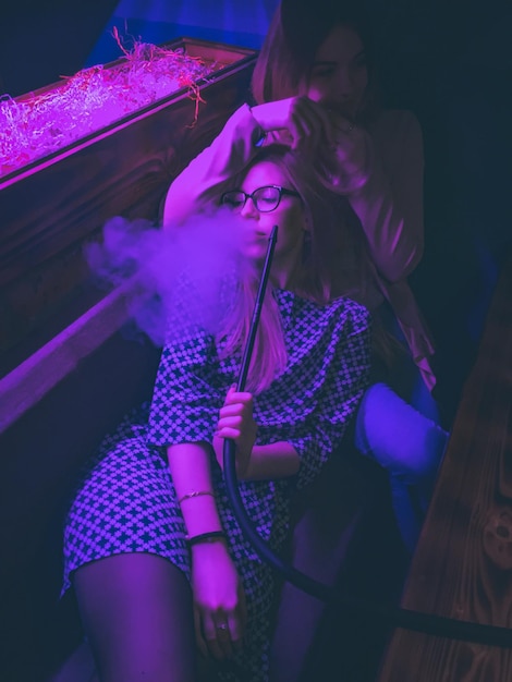 high angle view of women smoking hookah at nightclub