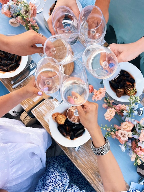 high angle view of women toasting wineglasses at table