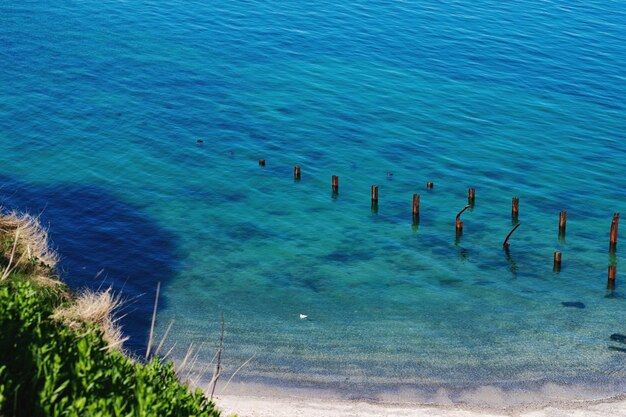 High angle view of wooden posts at beach