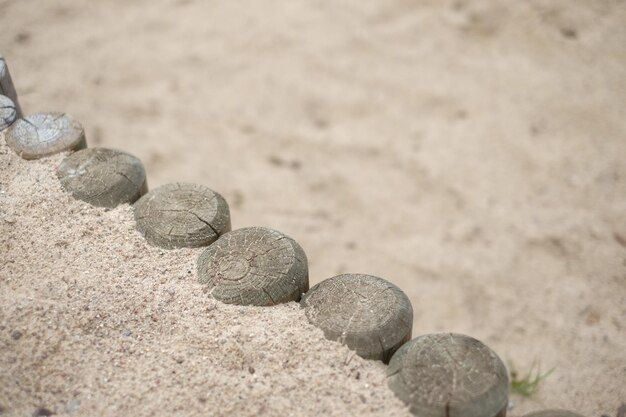 High angle view of wooden posts by sand at beach