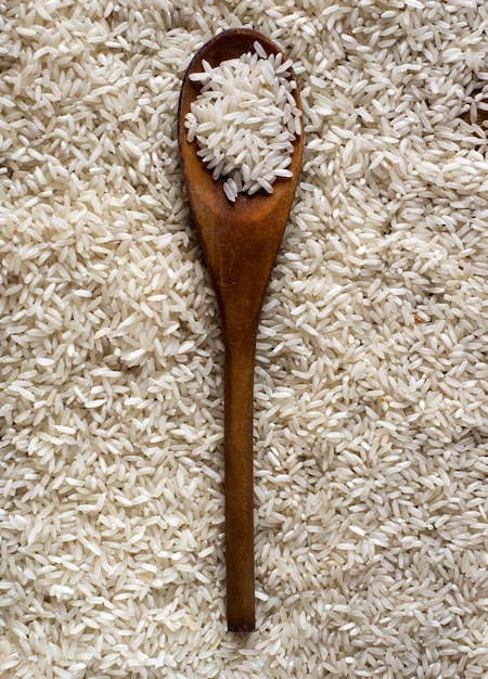 High angle view of wooden spoon on rice grain