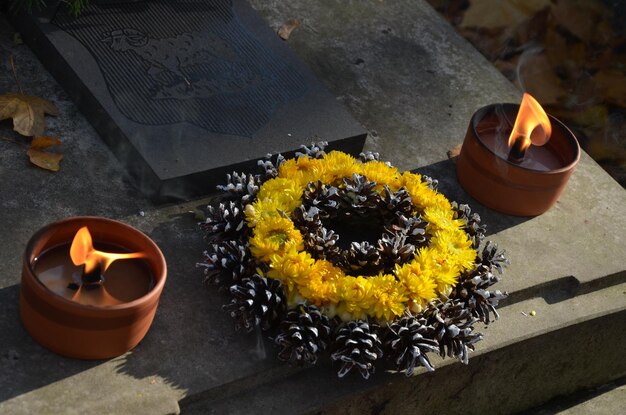 High angle view of wreaths and oil lamps at cemetery