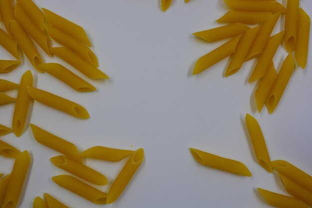 High angle view of yellow colored pencils on white background