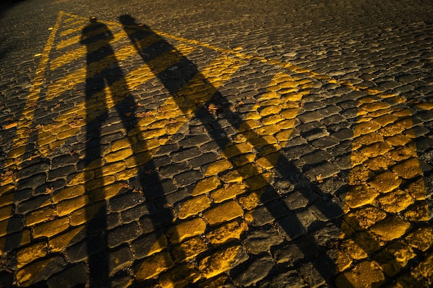 High angle view of yellow shadow on street