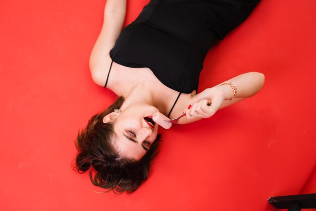 High angle view of young woman exercising against yellow background