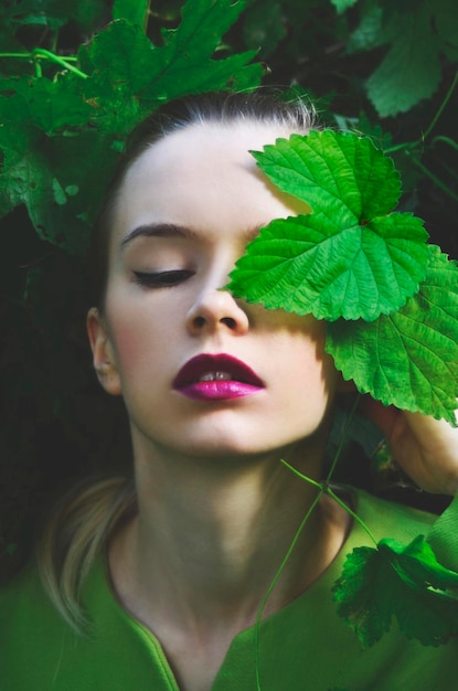 high angle view of young woman lying amidst plants on field