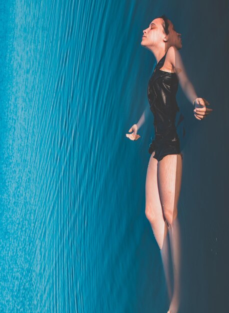 High angle view of young woman swimming in pool