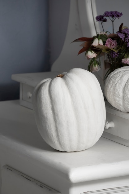 High angle white pumpkins with flowers