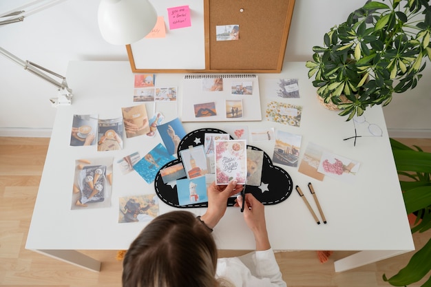 Photo high angle woman holding photos