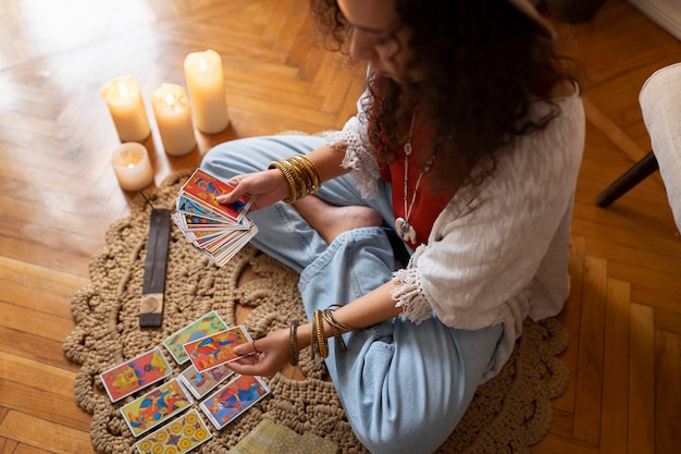 High angle woman reading tarot at home