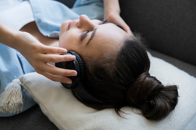 high angle woman wearing headphones