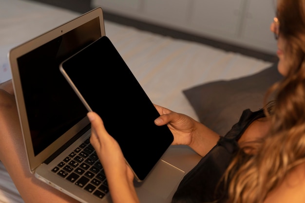 high angle woman with tablet and laptop