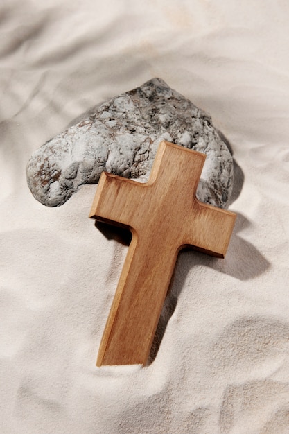 High angle wooden cross and rock