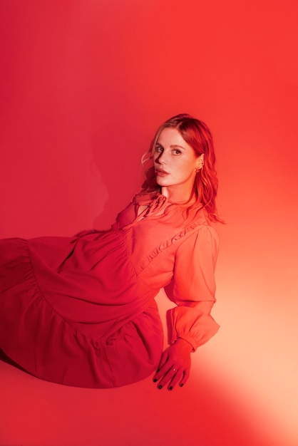 High angle young woman posing in red dress