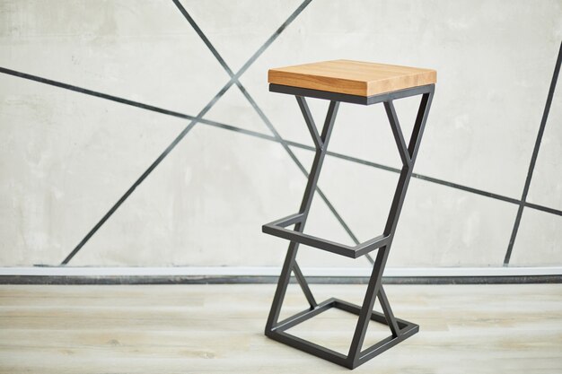 high bar stool made of wood and metal. photo with copy space