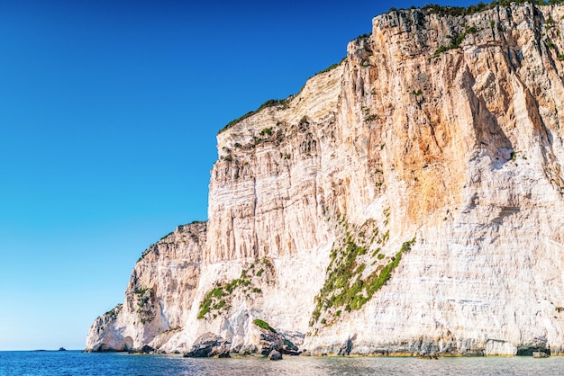 High cliffs with forest and rocks on shore of Corfu island