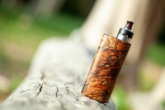 High end natural stabilized wood box mods with rebuildable dripping atomizer, vaping device, selective focus