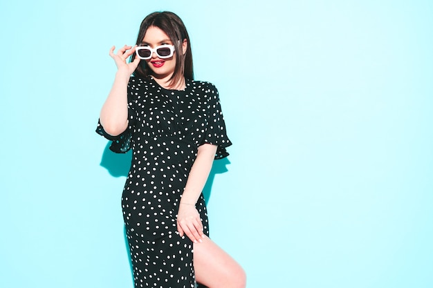 High fashion portrait of young beautiful brunette woman wearing nice trendy summer polka-dot dress 