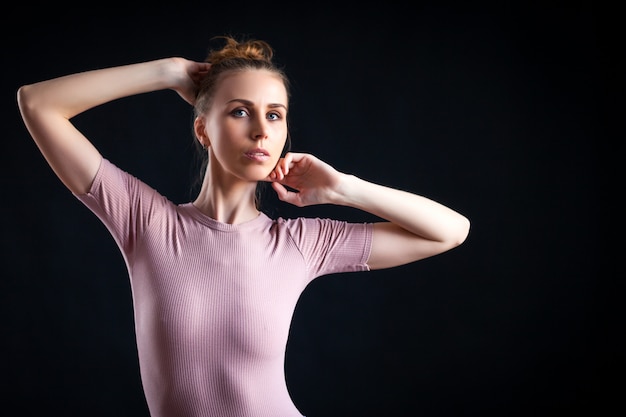 High fashion portrait of young elegant woman on beige top.