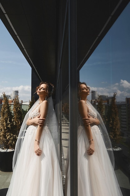 High fashion shot of a gorgeous young woman in a luxurious bridal dress and her reflection stunning ...