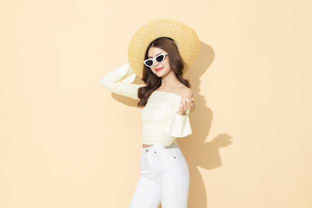 High fashion of young woman wearing sunglasses summer hat on copy space isolated pastel background