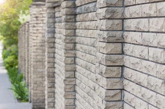 High fence made of stone, background.