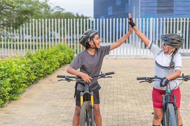 Photo high five between generations on bikes