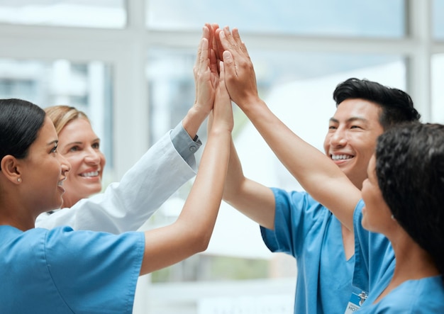 Photo high five happy or doctors with medical success in celebration of surgery results in hospital with bonus team work winners or nurses smiling to celebrate targets mission or winning goals together