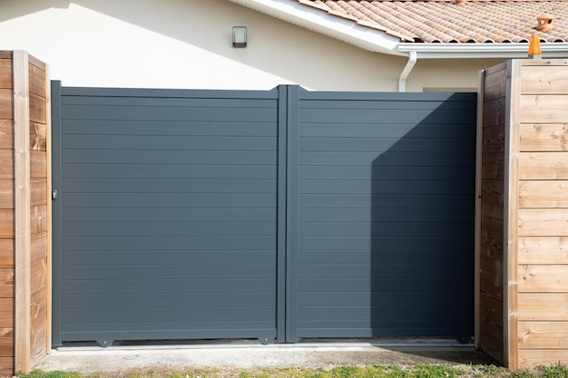 High gray gate steel big grey metal portal entrance on modern house street