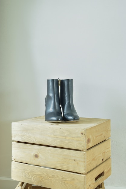 High heel boots on wooden box in walk in closet