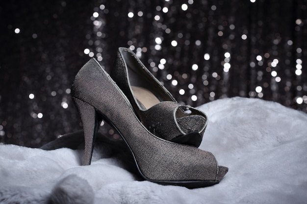High Heels shoes on fur and silver wallpaper
