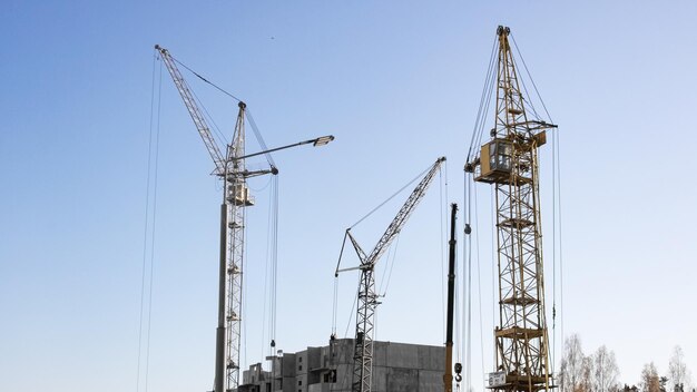 High house construction and construction cranes close up