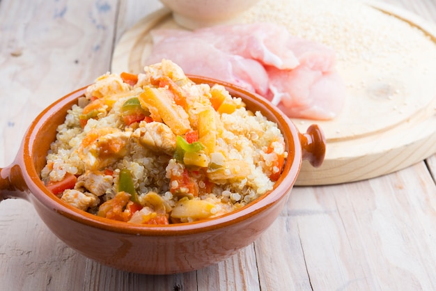 High-key image of white plate with quinoa lentil salad and bowl