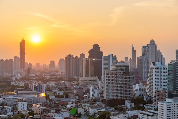 High modern building in business city center of Bangkok at sunset