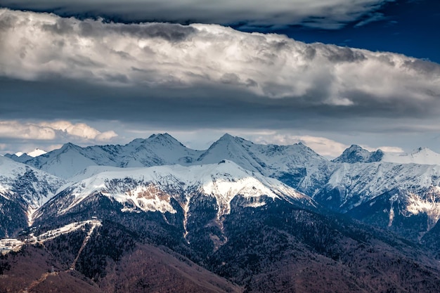 High mountain peaks covered with snow on a cloudy day