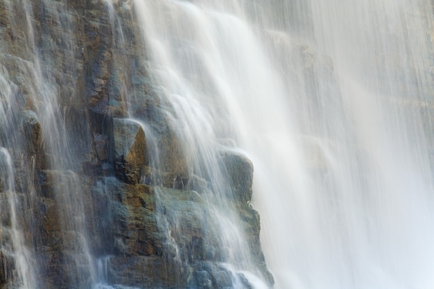 High mountain waterfall in dark wild Carpathian forest