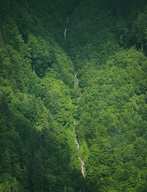 High narrow waterfall taken from afar