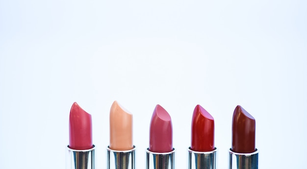 High quality lipstick. Cosmetics artistry. Lipstick for professional make up. Pick color which suits you. Compare makeup products. Lip care concept. Lipsticks on white background. Daily make up.