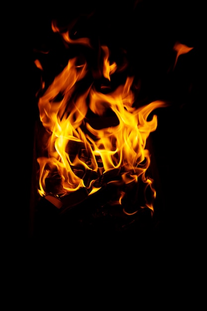 High resolution photo of flame and sparkl on black table. fire flames. table Texture. Elemen for design abstract of movement of fire flames