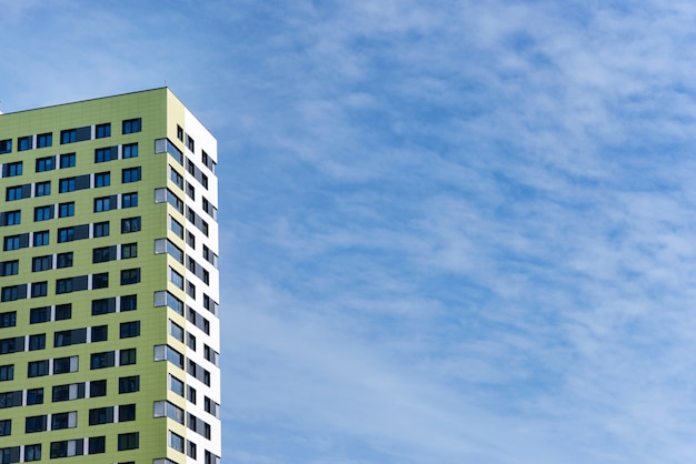 High-rise building on a wall of blue sky.