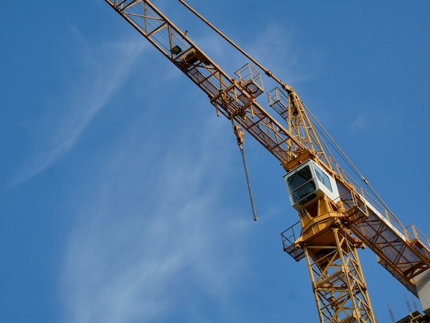 High-rise construction crane against the blue sky