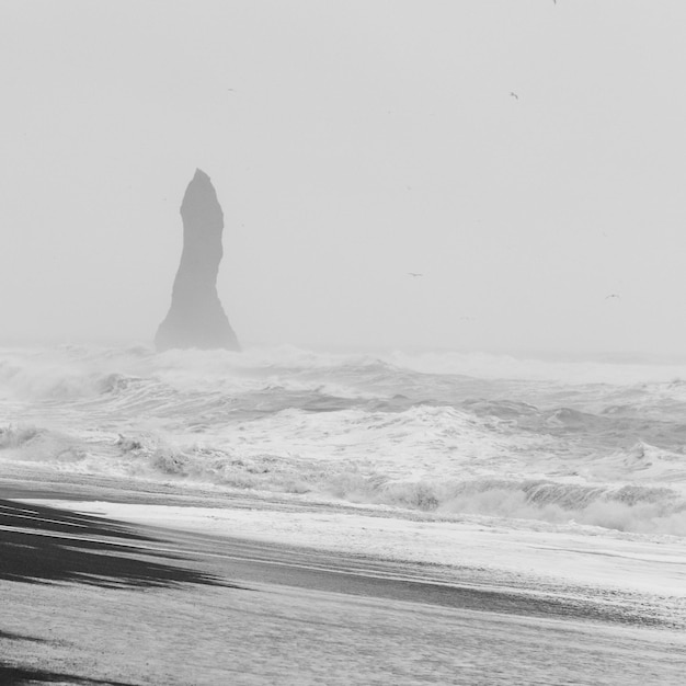 High rock and stormy sea monochrome landscape photo