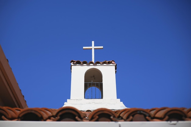 Photo high section of cross against clear blue sky